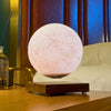 Lunara Moon Lamp glowing softly on bedroom nightstand