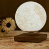 Lunara Moon Lamp warm close-up floating above walnut base