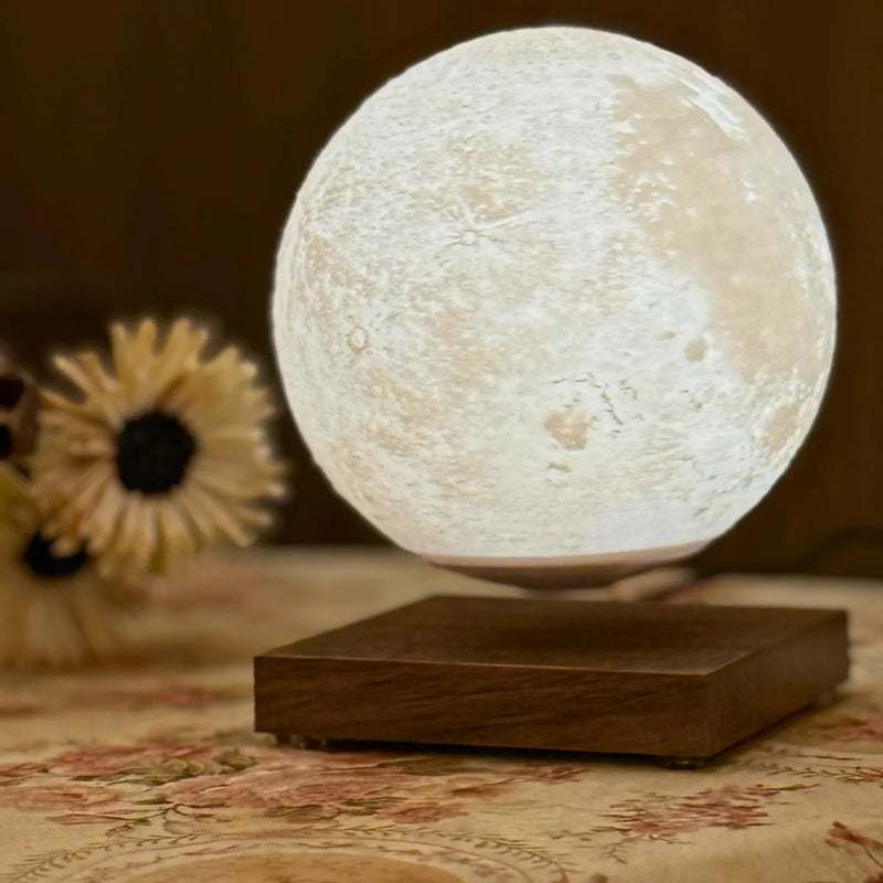 Lunara Moon Lamp warm close-up floating above walnut base